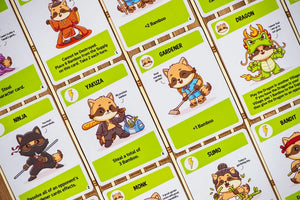 Afbeelding van het bordspel Tanuki, te koop bij Speldorado. Het spel heeft een Japans thema met schattige tanuki-figuren en kleurrijke kaarten